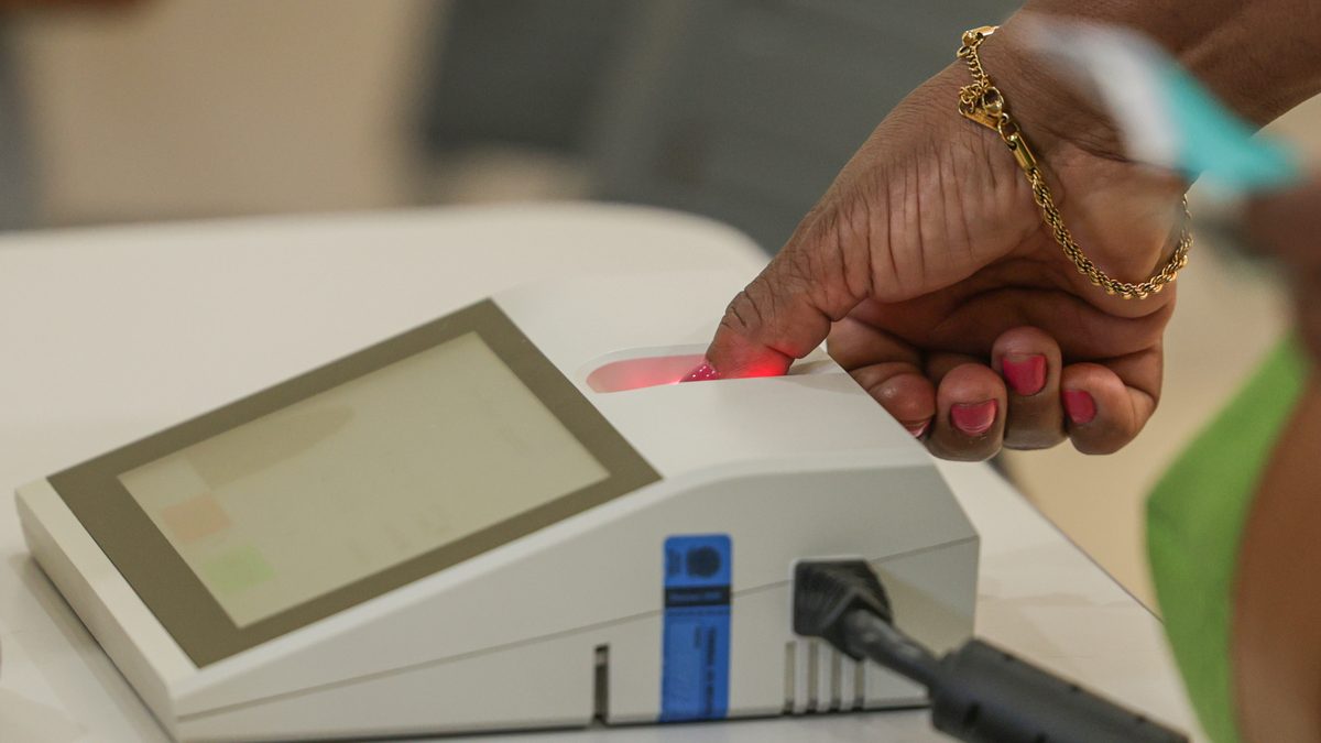 Eleitora coloca o dedo no leitor de biometria da urna eletrônica em seção eleitoral de Brasília, na manhã do primeiro turno