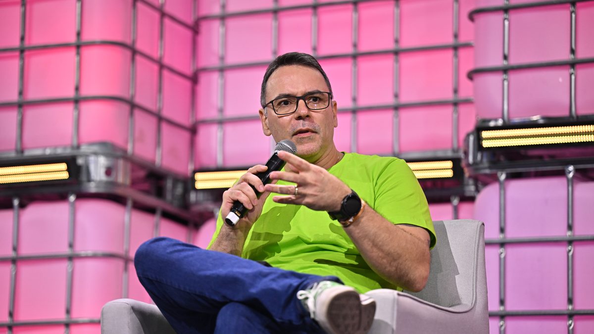 Edu Neves, CEO do Reclame Aqui, fala ao microfone sentado em uma poltrona no palco do Web Summit Rio, em abril de 2025